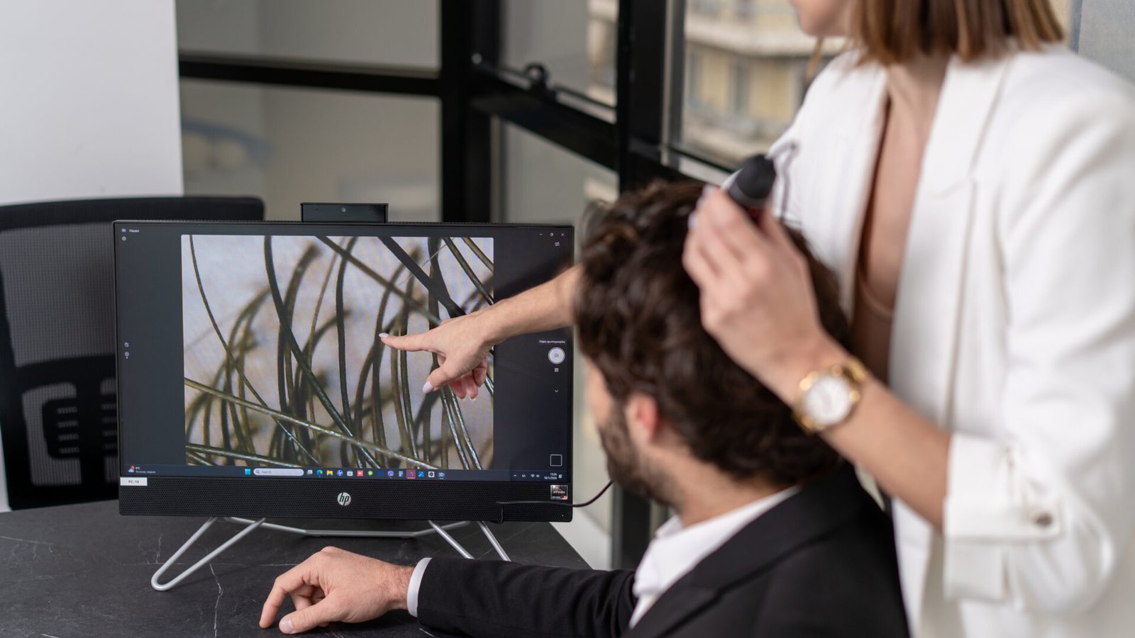 Hair follicle analysis displayed on screen during hair loss diagnosis